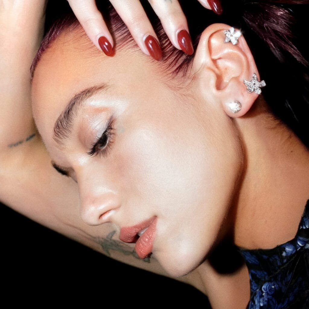 Dua Lipa helix piercing with a small gold hoop