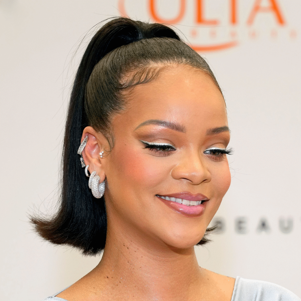 Rihanna Ear Piercings with asymmetrical gold hoops and diamond studs
