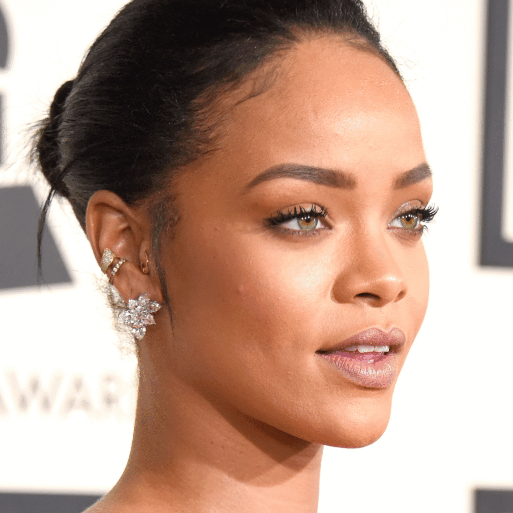 Rihanna Ear Piercings with bold conch hoop and stacked studs