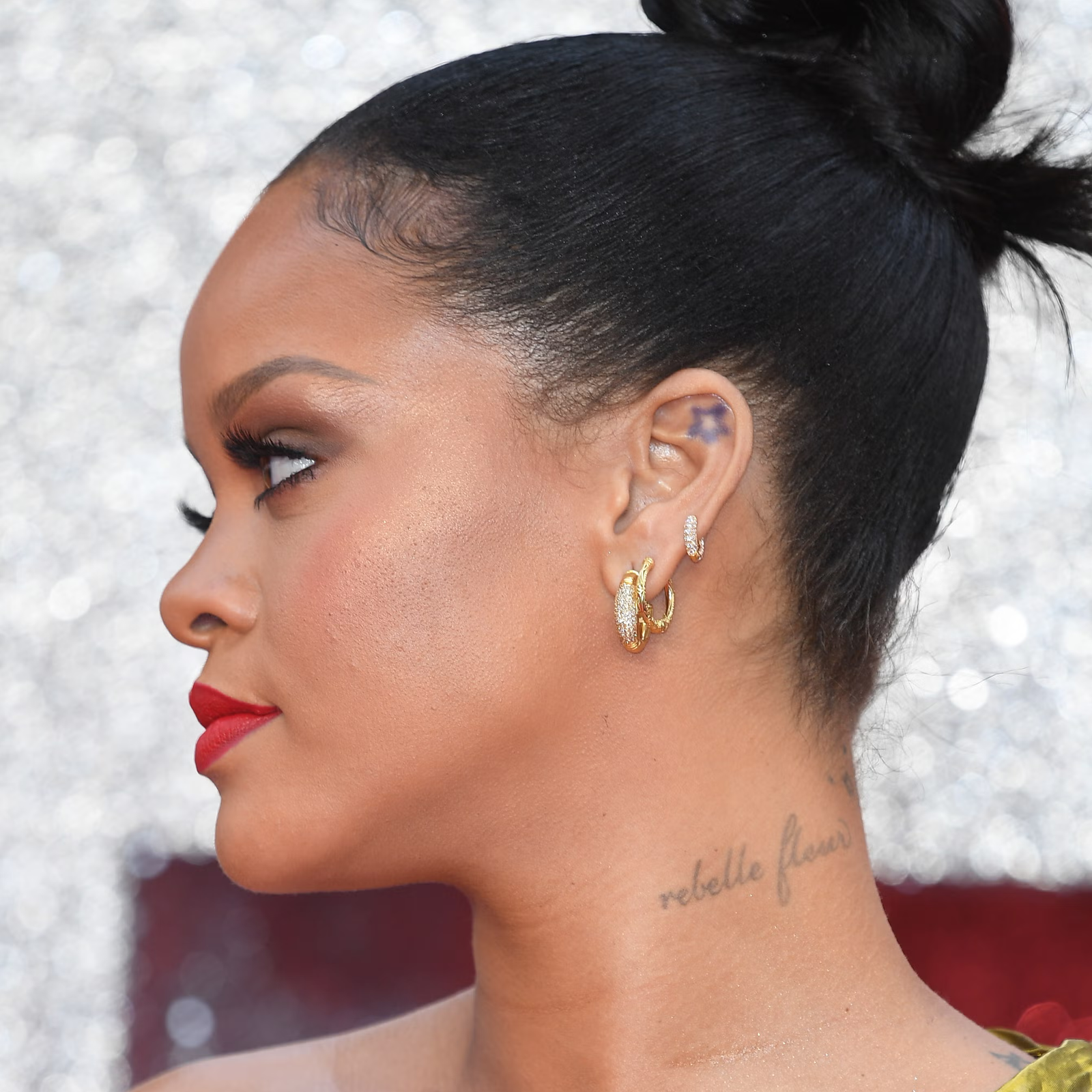 Rihanna Ear Piercings with multiple gold and diamond lobe hoops