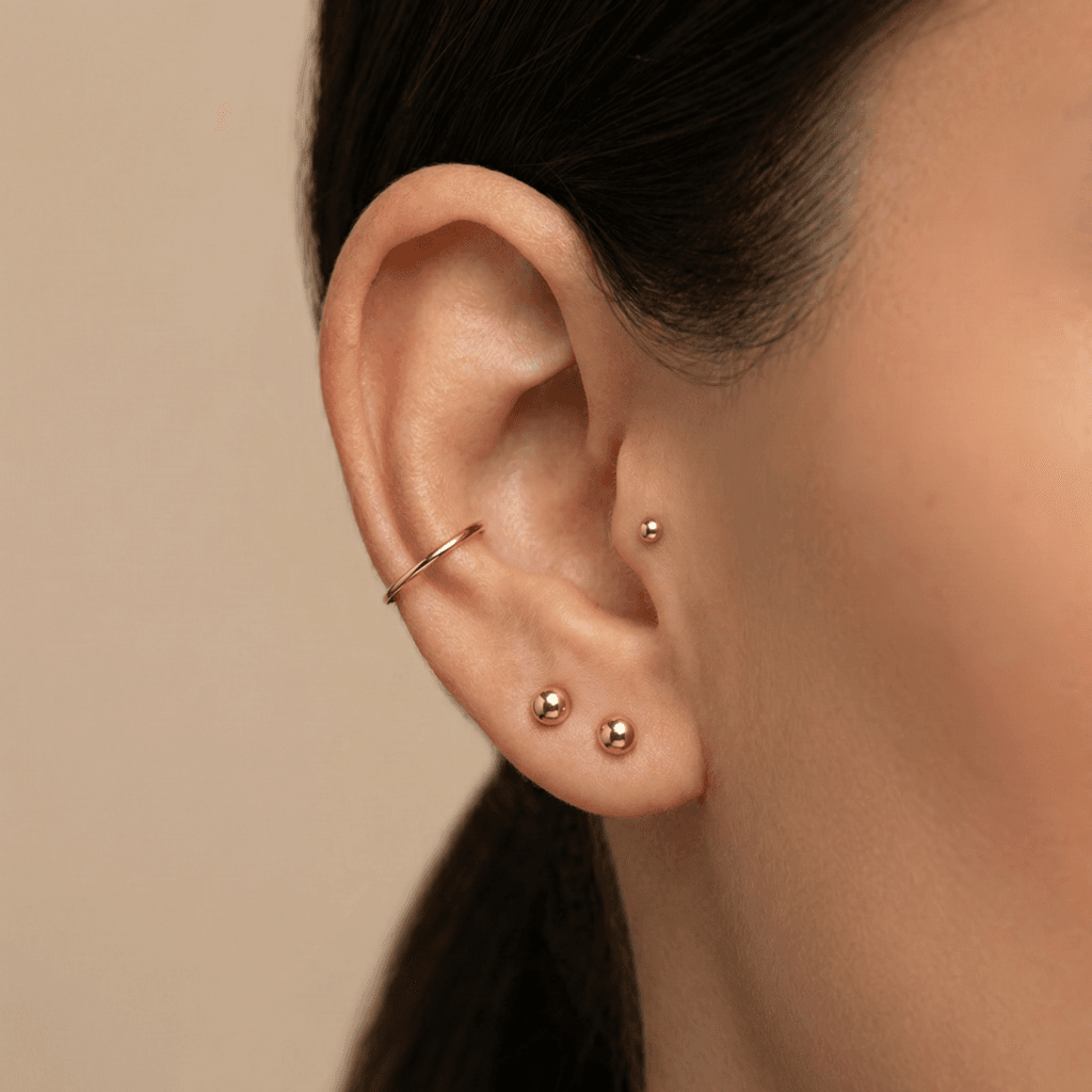 Balanced trio curated ear with double lobe helix and tragus piercings