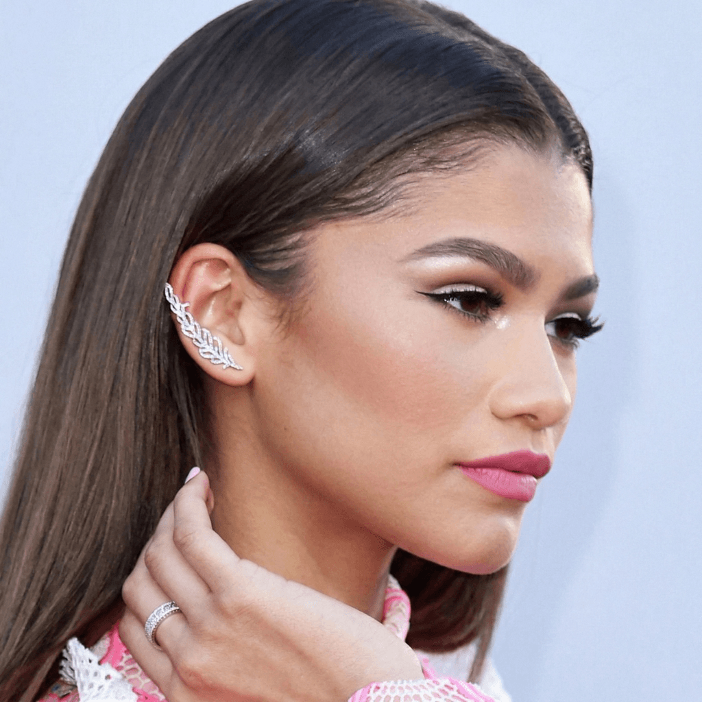 Zendaya wearing a gold ear stack with multiple lobe piercings on the red carpet