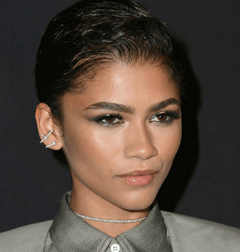 Close up of Zendaya helix piercing styled with a thin gold hoop
