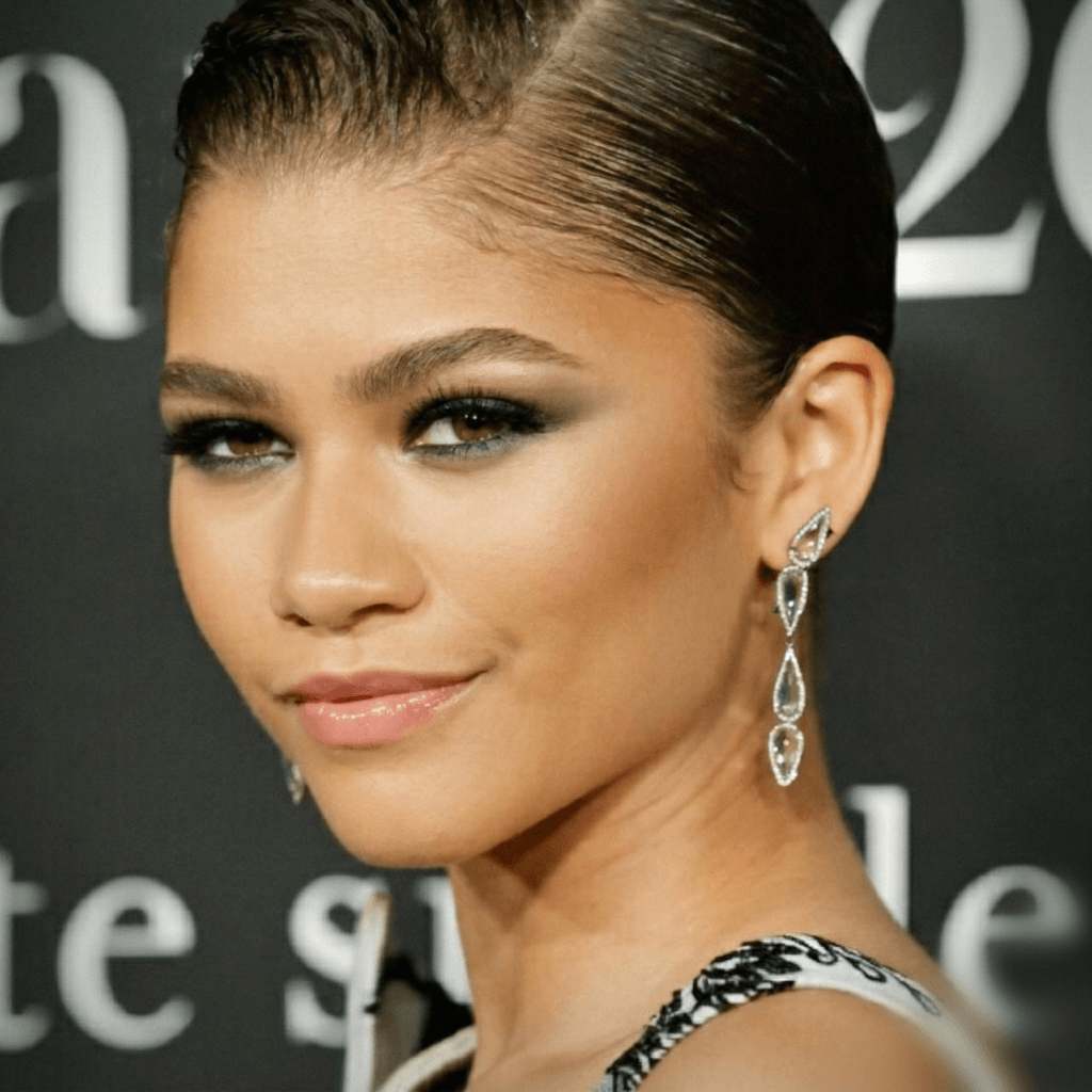 Zendaya minimal lobe piercings with small gold stud earrings