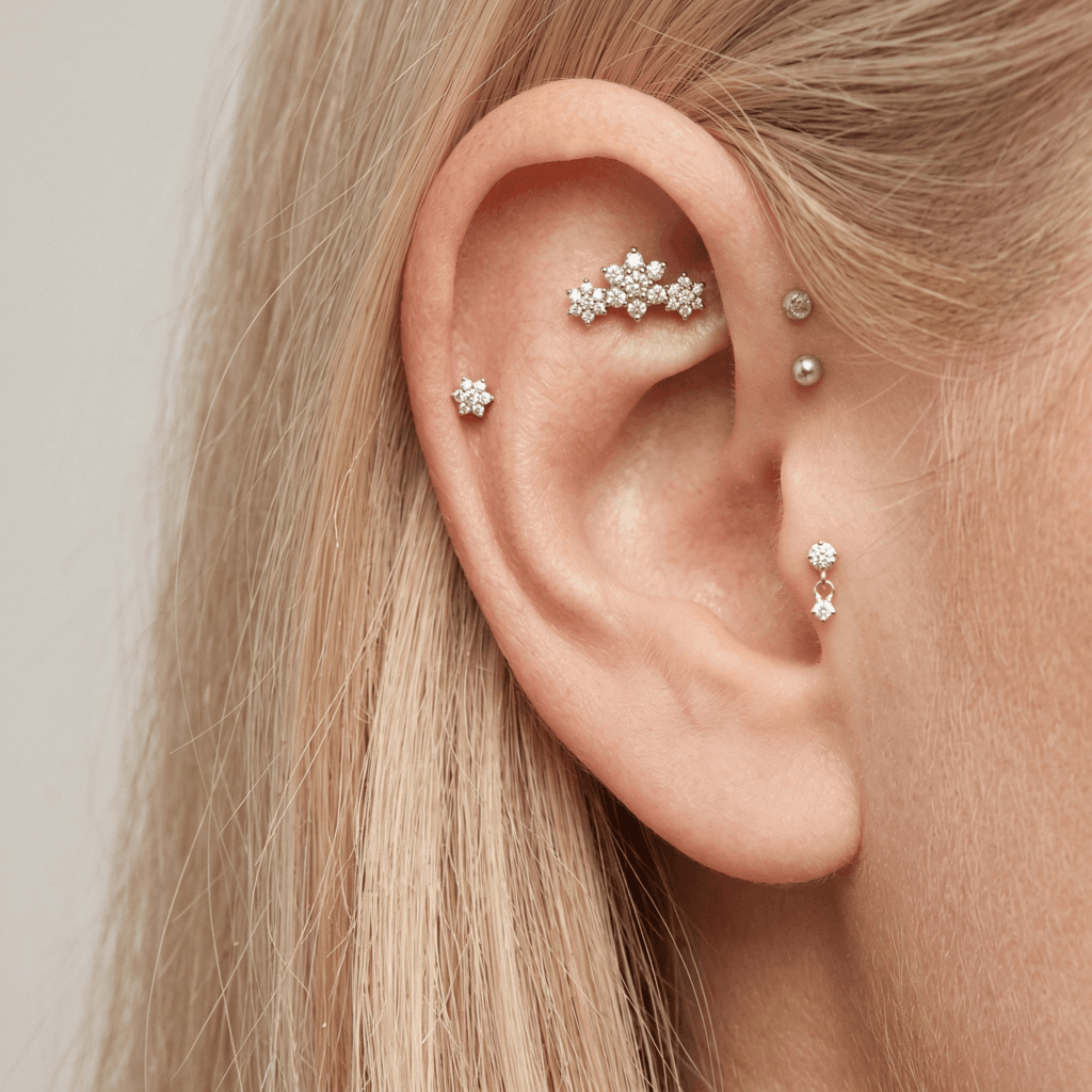 Anatomical placement guide for a tash rook piercing on the upper flat cartilage of a curated ear.