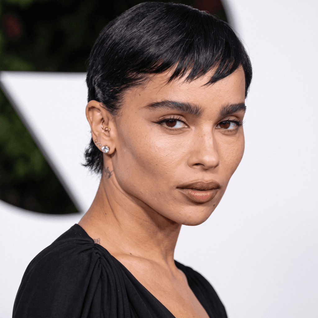 A Zoë Kravitz inspired ear stack combining gold cartilage hoops, tiny studs, and a pearl lobe earring